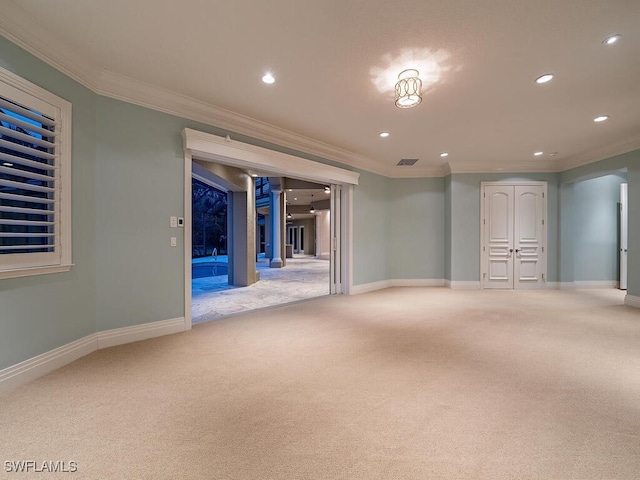 basement with ornamental molding and carpet