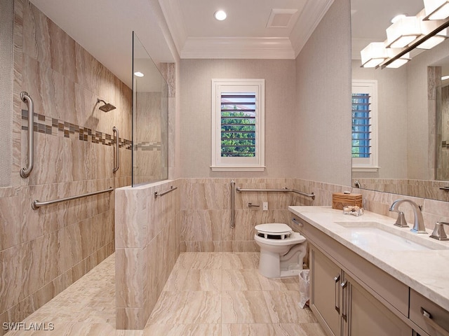 bathroom with vanity, a tile shower, tile walls, and toilet