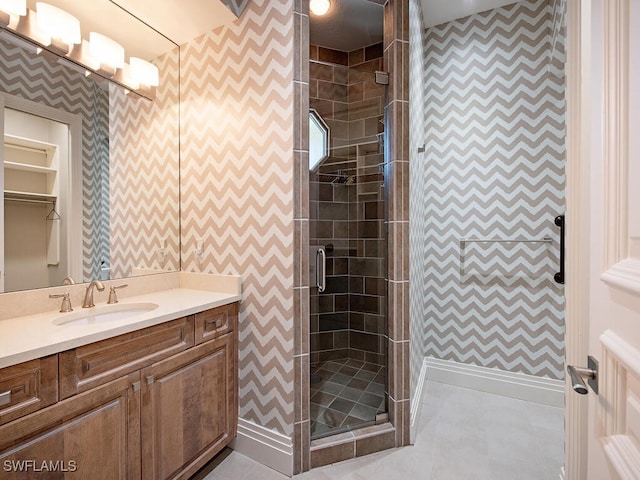 bathroom with a shower with door and vanity