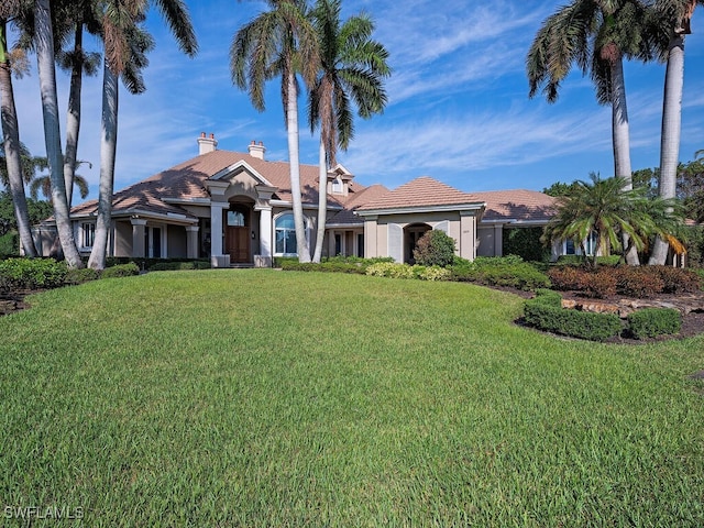 2835 Silverleaf Ln, Naples, FL 34105 - mediterranean / spanish house with a front yard, stucco siding, and a chimney