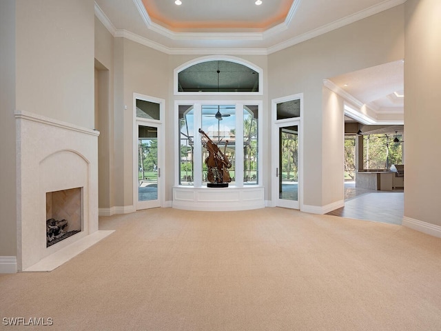 2835 Silverleaf Ln, Naples, FL 34105 - carpeted foyer entrance featuring a high end fireplace, ornamental molding, a raised ceiling, ceiling fan, and a high ceiling