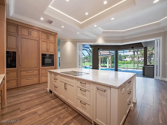 2835 Silverleaf Ln, Naples, FL 34105 - kitchen with a tray ceiling, crown molding, black appliances, plenty of natural light, and wood finished floors