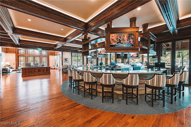 bar with coffered ceiling, wood-type flooring, beamed ceiling, and ornamental molding