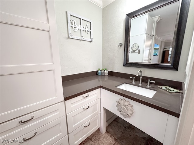 bathroom with crown molding, vanity, and tile patterned flooring