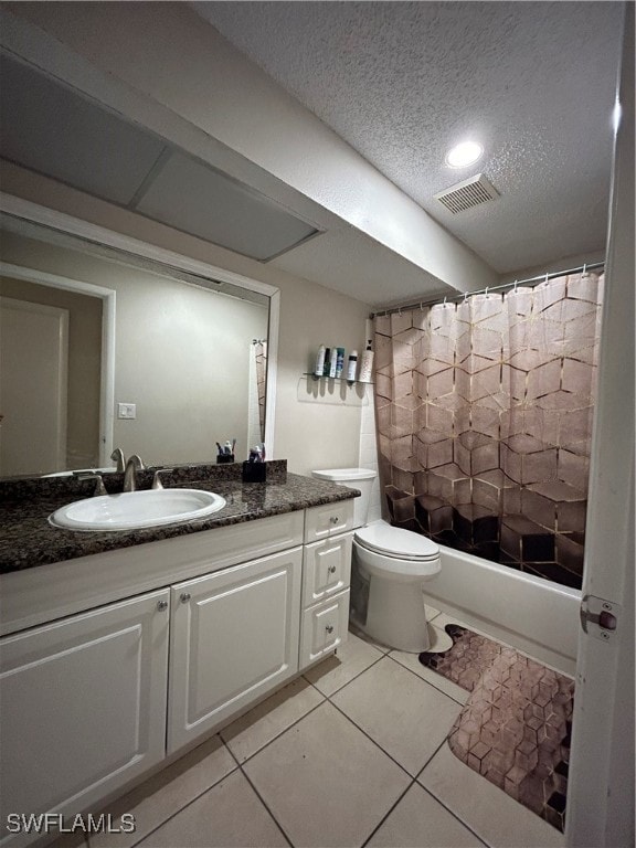 full bathroom with tile patterned floors, vanity, and toilet