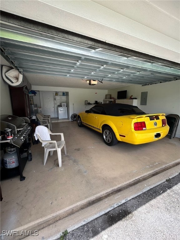 garage featuring electric panel and a garage door opener