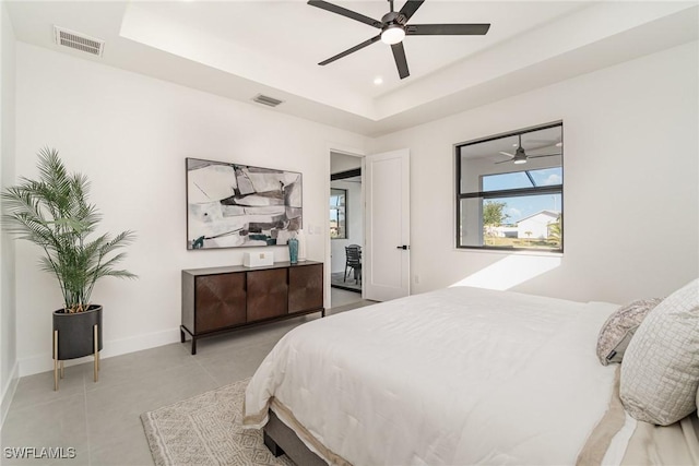 bedroom with a tray ceiling and ceiling fan