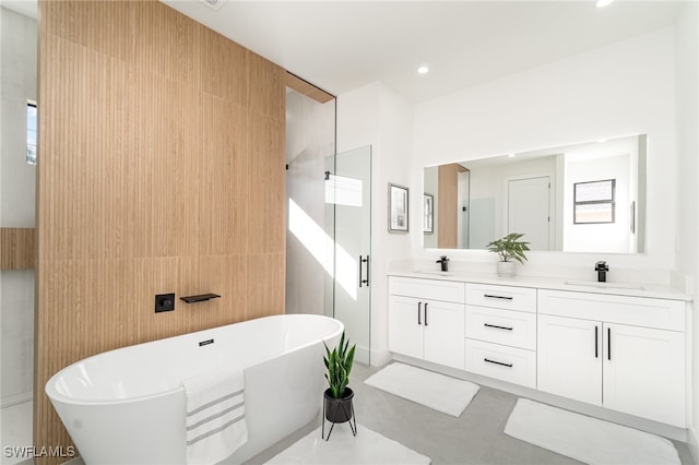 bathroom featuring vanity and independent shower and bath