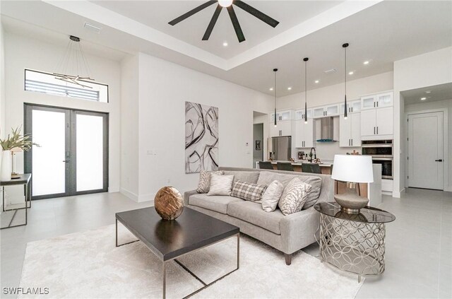 living area featuring recessed lighting, a high ceiling, a ceiling fan, and french doors