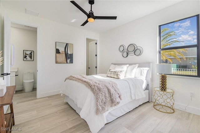 bedroom with ceiling fan, ensuite bathroom, and light hardwood / wood-style floors