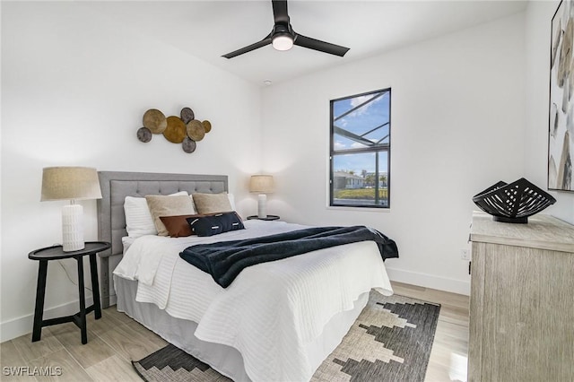 bedroom with ceiling fan and light hardwood / wood-style floors