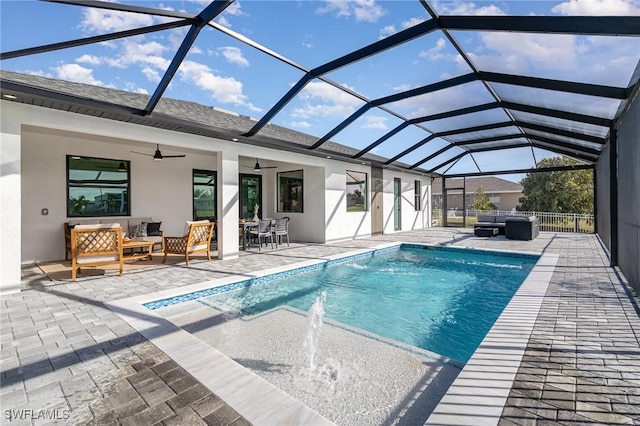 view of pool featuring a lanai, an outdoor hangout area, a patio, and ceiling fan