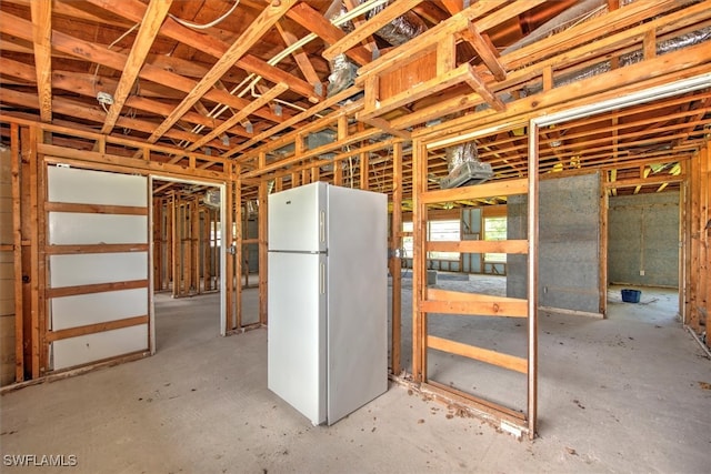 basement featuring white refrigerator