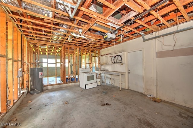 interior space with electric water heater, concrete floors, and washer / dryer