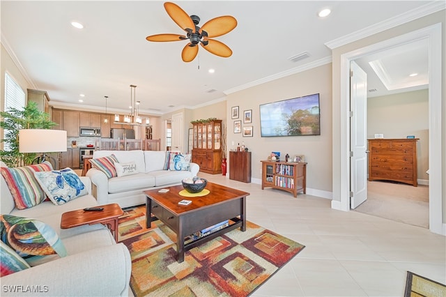 tiled living room featuring ceiling fan and crown molding