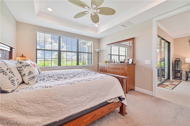 tiled bedroom featuring ceiling fan, access to outside, a tray ceiling, and ornamental molding