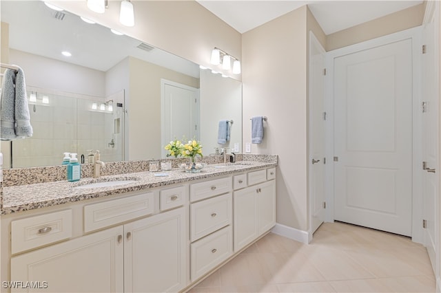 bathroom with dual vanity and tile patterned flooring