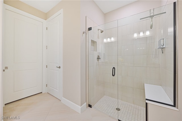 bathroom featuring tile patterned flooring and an enclosed shower