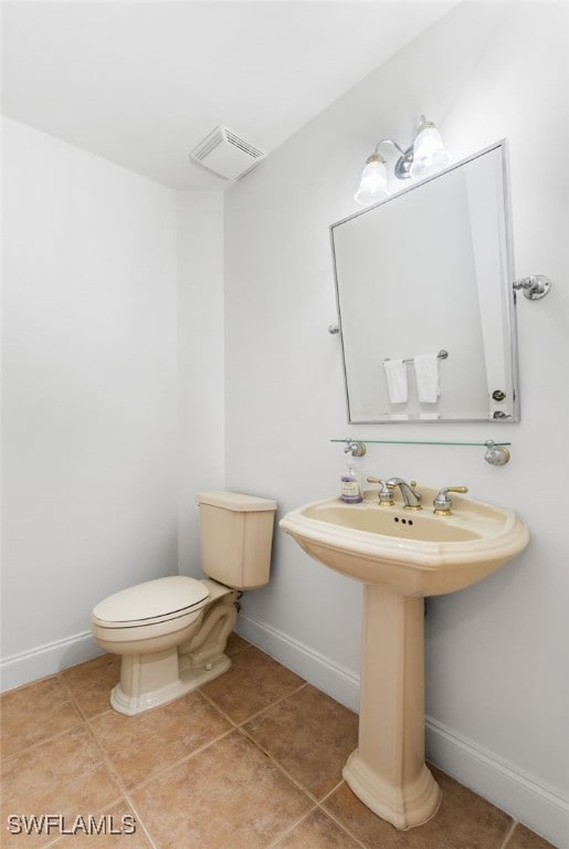 bathroom featuring tile patterned flooring, visible vents, and baseboards