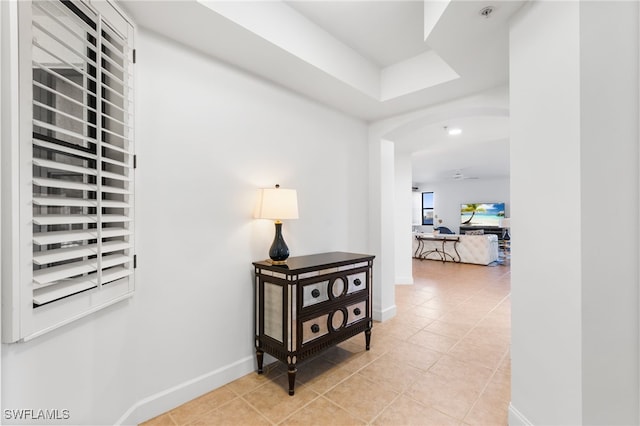 hall featuring light tile patterned floors