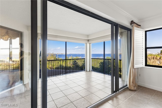 unfurnished sunroom featuring a water view