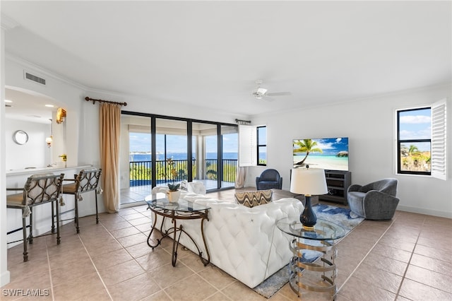11600 Court Of Palms Unit 206, Fort Myers, FL 33908 - living room featuring tile patterned floors, ornamental molding, ceiling fan, and arched walkways