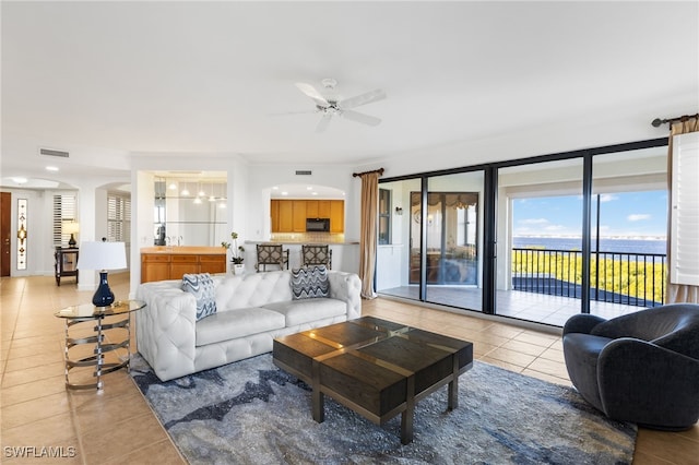 11600 Court Of Palms Unit 206, Fort Myers, FL 33908 - living area featuring light tile patterned floors, ceiling fan, and arched walkways