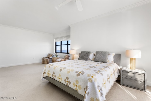 bedroom featuring ceiling fan, ornamental molding, and light carpet