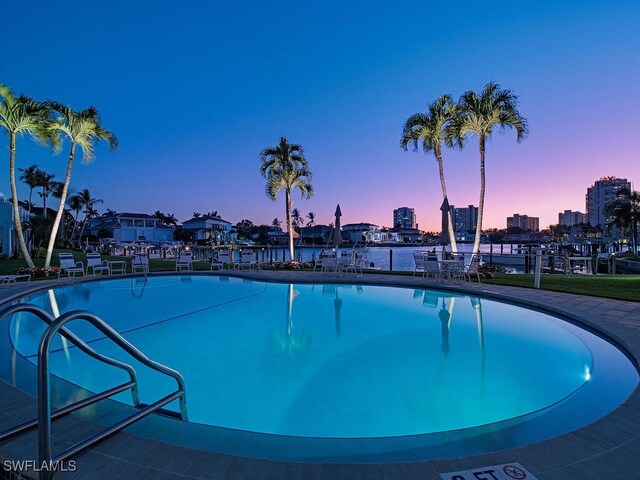 view of pool at dusk