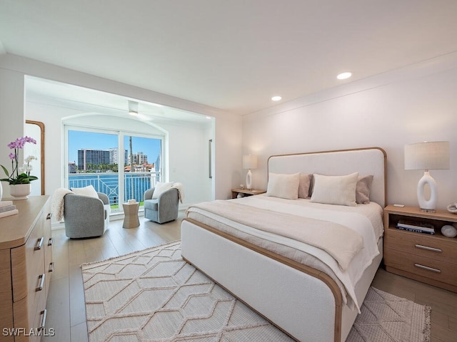 bedroom featuring light hardwood / wood-style floors and access to outside