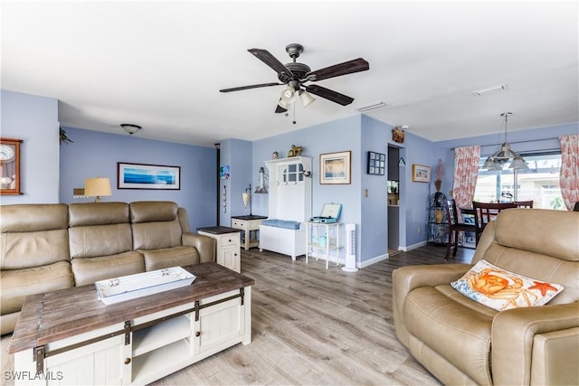 living room with ceiling fan and light hardwood / wood-style floors