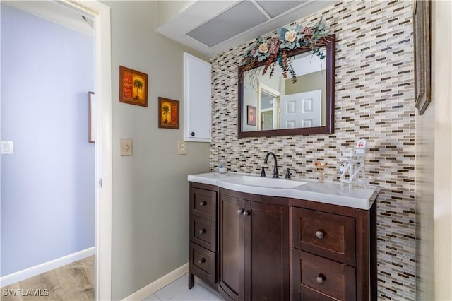 bathroom featuring vanity and decorative backsplash