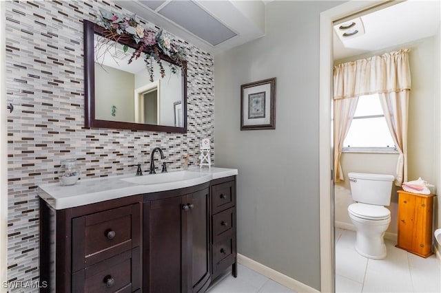 bathroom featuring vanity, toilet, tile patterned flooring, and decorative backsplash