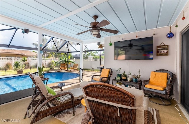 view of patio with a fenced in pool, ceiling fan, and glass enclosure