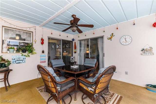 dining room with ceiling fan and carpet