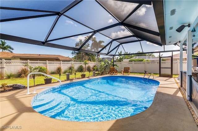 view of pool featuring a patio area and glass enclosure