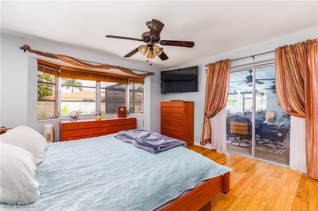 bedroom with access to exterior, light hardwood / wood-style flooring, and ceiling fan