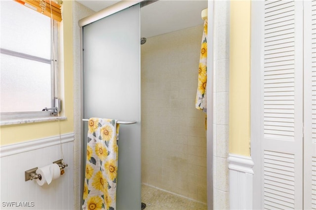 bathroom with a shower with door