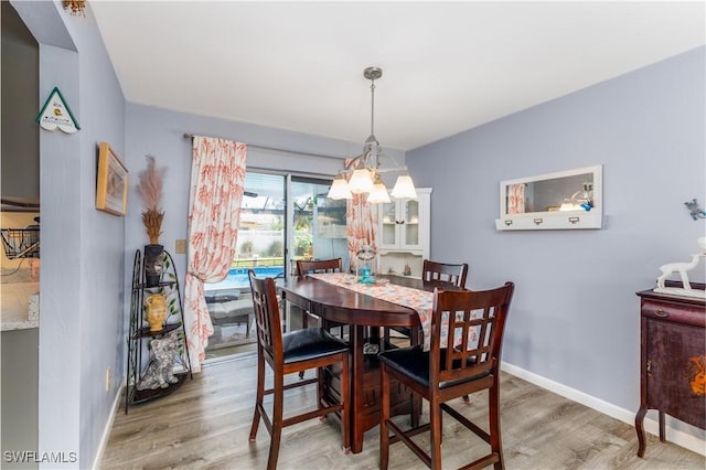 dining space with hardwood / wood-style floors