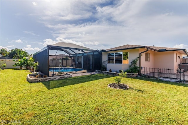 back of property with a fenced in pool, a yard, and glass enclosure