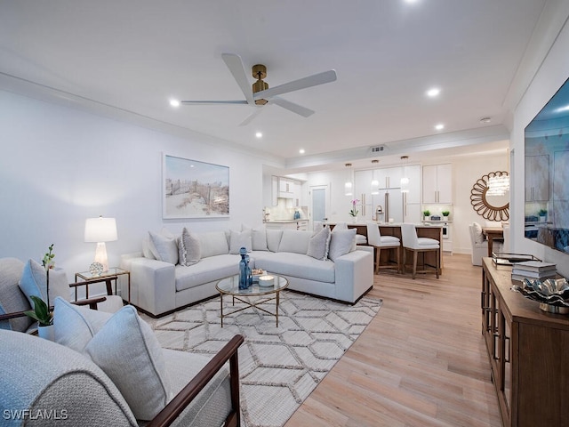 living room with ceiling fan and light hardwood / wood-style flooring