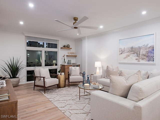 living room featuring ceiling fan and light wood-type flooring