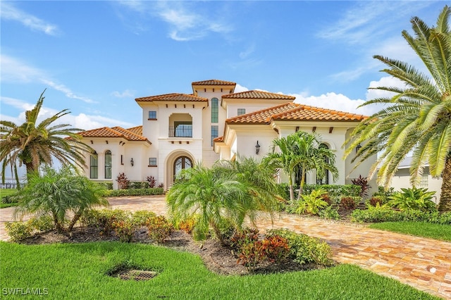 614 Coral Dr, Cape Coral, FL 33904 - mediterranean / spanish-style house with driveway, stucco siding, and a tile roof