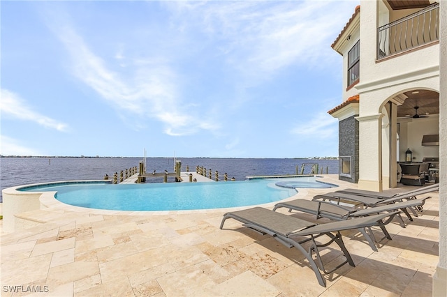 614 Coral Dr, Cape Coral, FL 33904 - view of swimming pool with a patio area, a grill, a water view, and a pool with connected hot tub