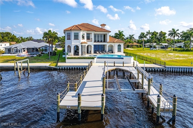 dock area featuring a lawn, a water view, and a patio area