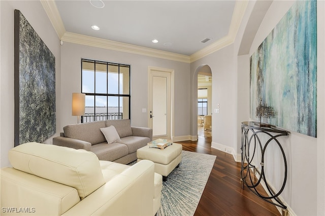 614 Coral Dr, Cape Coral, FL 33904 - living room featuring arched walkways, ornamental molding, dark wood finished floors, and a healthy amount of sunlight