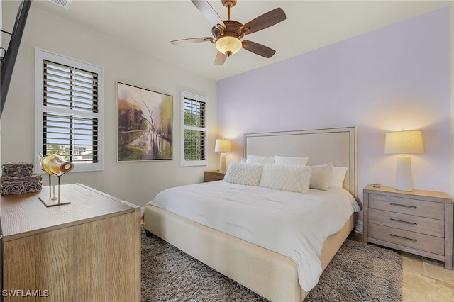 bedroom with multiple windows and ceiling fan