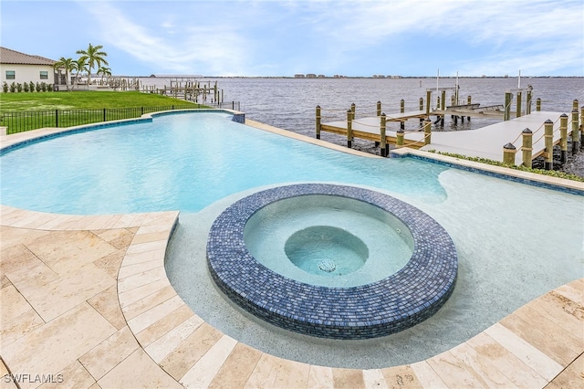 view of swimming pool with a dock, a water view, and an in ground hot tub