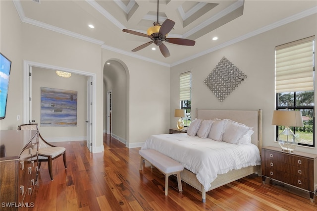 bedroom featuring beamed ceiling, coffered ceiling, hardwood / wood-style floors, ornamental molding, and ceiling fan