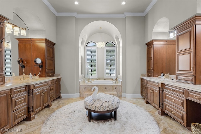 bathroom with vanity, a tub, and crown molding